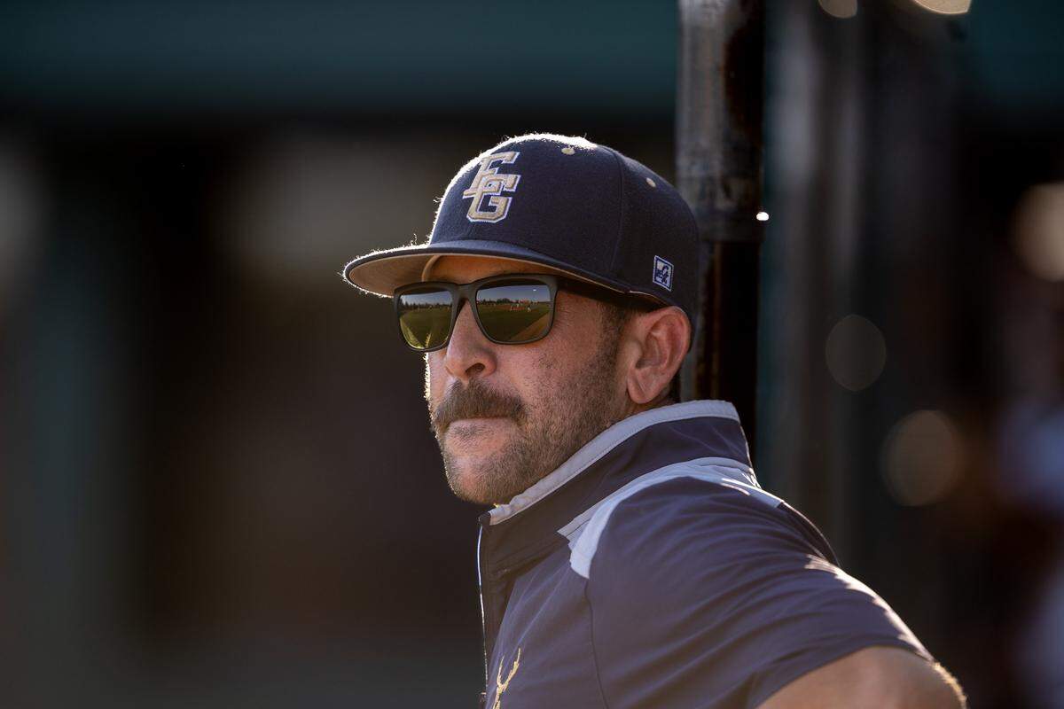 Elk Grove Thundering Herd coach Joe Bellotti watches from the dugout against the Rodriguez Mustangs on Thursday in the CIF Sac-Joaquin Section Division II baseball championship at Sacramento City College.