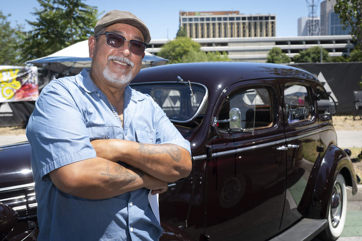 Frank Franco poses for a portrait with his 1937 Dodge during the fourth annual Lowrider Holiday Celebration in Sacramento on Sunday, June 21, 2026. Franco credits his oldest brother with getting him into lowriding and recalls helping load rocks in the back of his oldest brother’s truck to lower the back end of the car.
