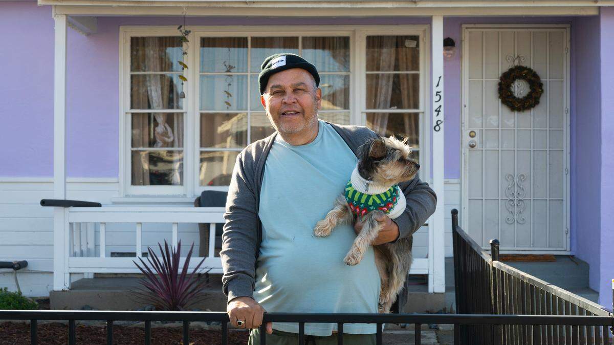 Vietnam veteran Rick Sanchez and his Yorkie Joey stand in front of their home in South Sacramento on Dec. 8. Habitat for Humanity helped him with fencing, landscaping, a new overhang and painting of his home. The organization is asking Book of Dreams readers to support its program that helps needy veterans with home upgrades and repairs.