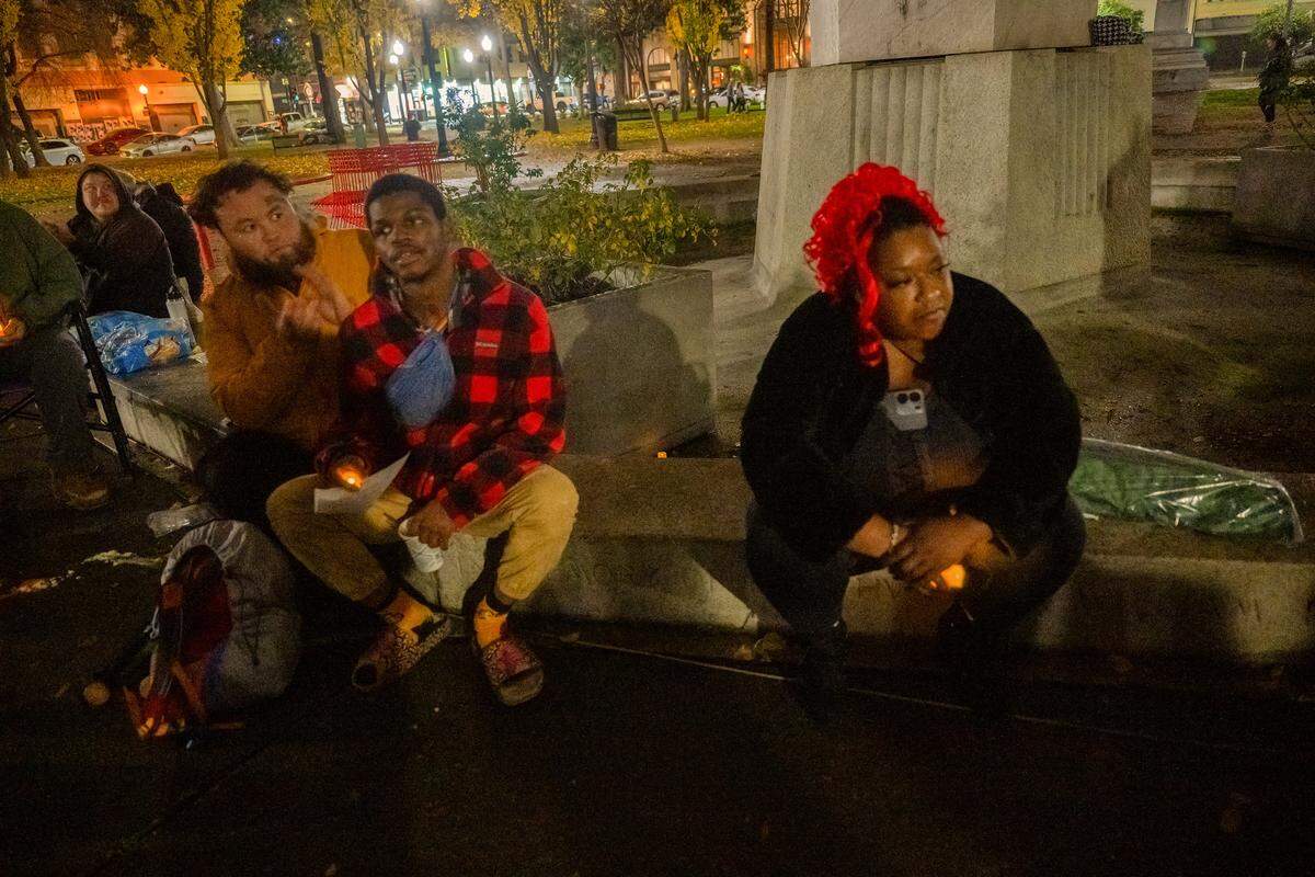 Satearah Murphy, right, attends a vigil at Cesar E. Chavez Plaza in Sacramento on Sunday to memorialize people who died this year while homeless in Sacramento County. Murphy, who lived in the former encampment known as Camp Resolution, is still unhoused but working. "Do you know how hard it is for me every single day to go to work from a tent? It’s hard. I’m tired. I’m burnt out," she said. "We are all doing the best that we can."