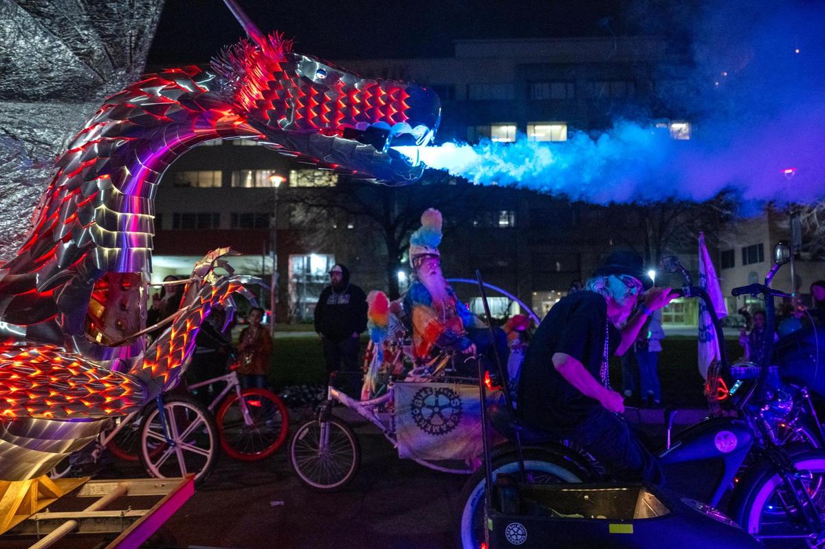 A metal dragon blows smoke from its mouth at the City of Trees Parade to celebrate Mardi Gras on Saturday.