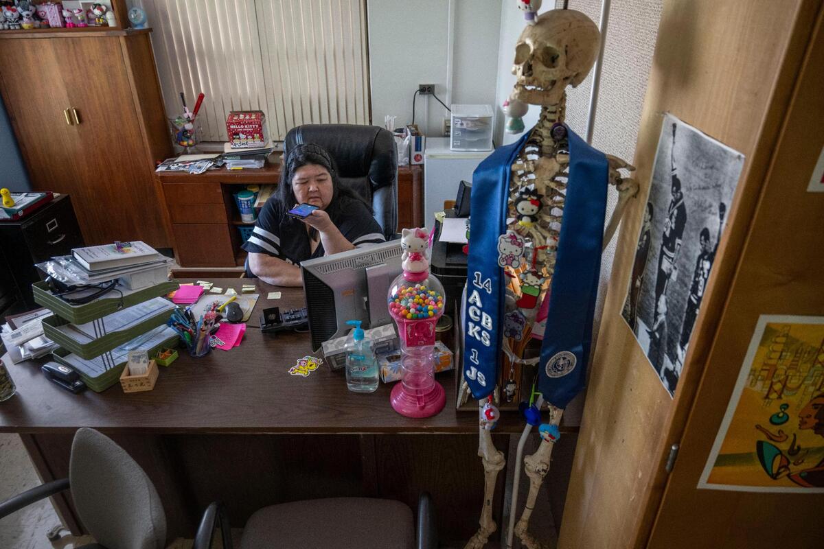 Lauren Morimoto, a professor at Sonoma State and chair of its Academic Senate, makes a phone call in her office Tuesday. “Sonoma State hasn’t really done a very good job at asserting its identity,” said Morimoto, referring to the school’s drastic drop in enrollment over the past couple of years.