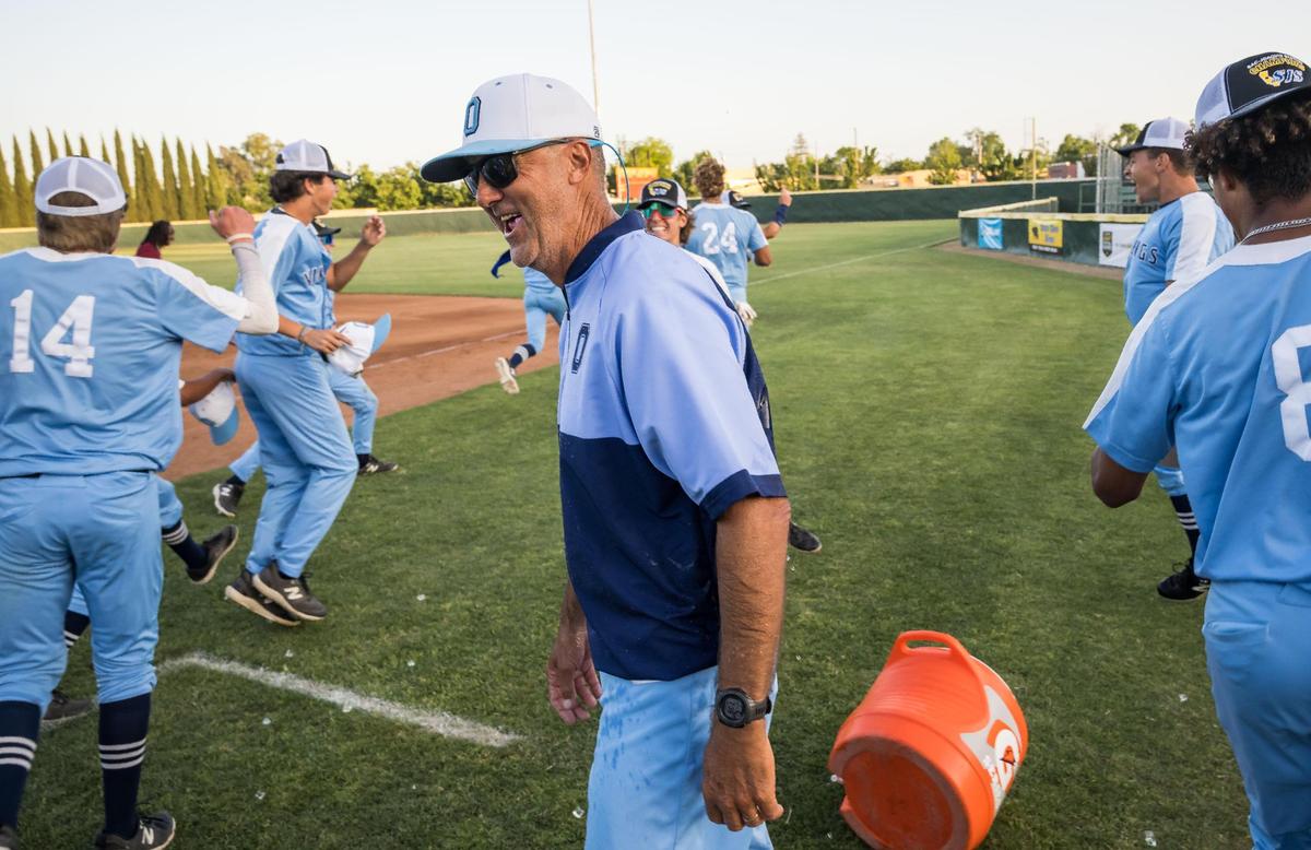 Oakmont Vikings head coach Paul Martinez laughs after being doused with ice by his players after their sub over the Woodland Wolves for the CIF Sac-Joaquin Section Division IV high school baseball title Wednesday, May 24, 2023, at Sacramento City College.