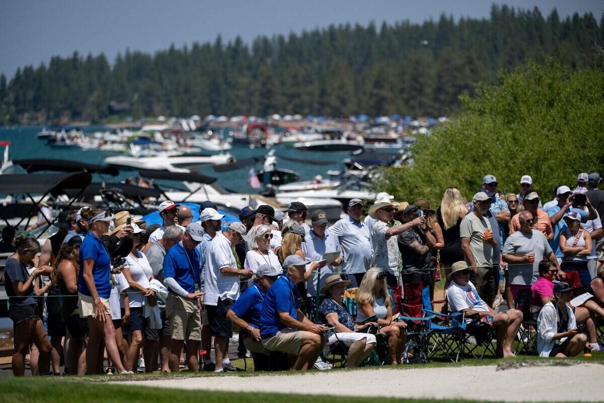 Fans line the 17th hole green along Lake Tahoe during the American Century Championship celebrity golf tournament at Edgewood Tahoe Resort in Stateline, Nev., on Friday, July 11, 2025.