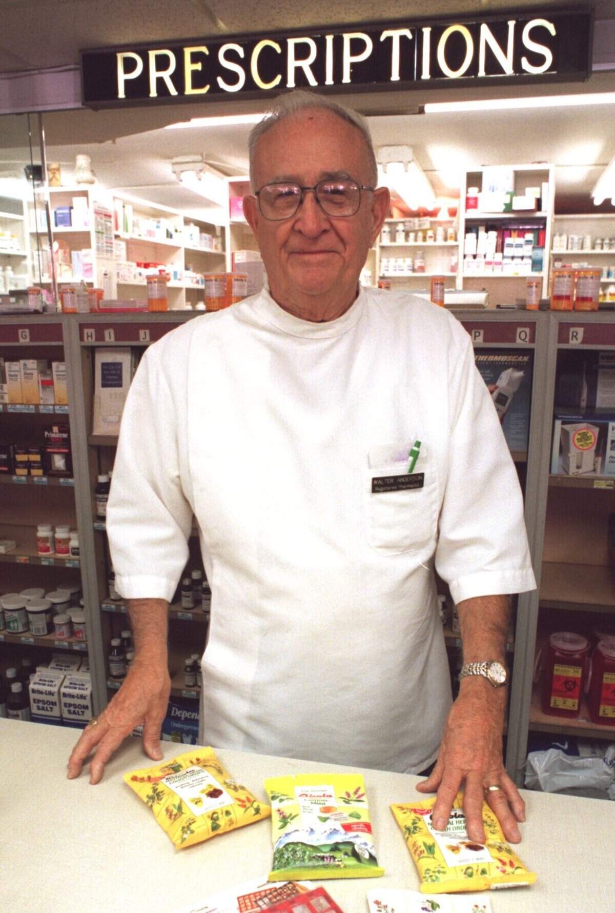 Walter Anderson stands at the prescription counter at his Town & Country Village Pharmacy in 1997. Anderson and his wife, Agnes, gave millions to Sacramento-area Catholic schools and charities.
