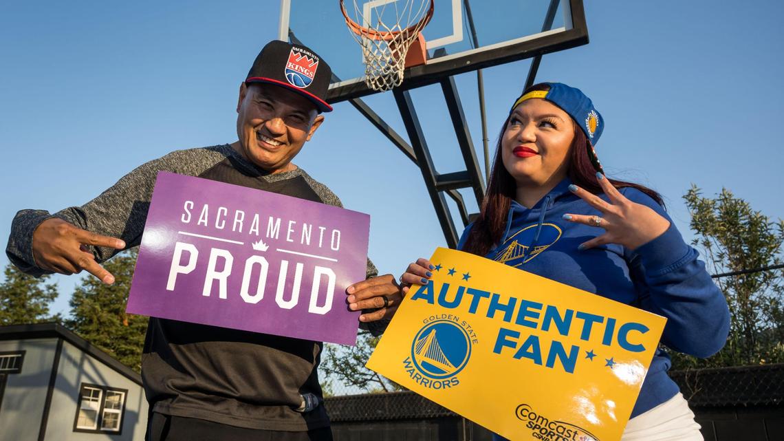 Sacramento Kings fan Robert Sangco, left, and his wife, Golden State Warriors fan Carmel Sangco, are on opposite sides of NBA playoff matchup. They stand on their backyard court Wednesday in Elk Grove.