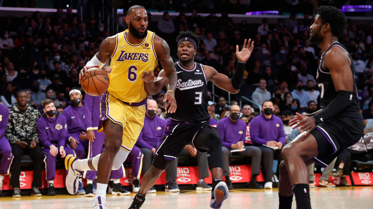 Los Angeles Lakers forward LeBron James (6) drives past Sacramento Kings guard Terence Davis II (3) during the first half of an NBA basketball game in Los Angeles, Friday, Nov. 26, 2021. (AP Photo/Ringo H.W. Chiu)