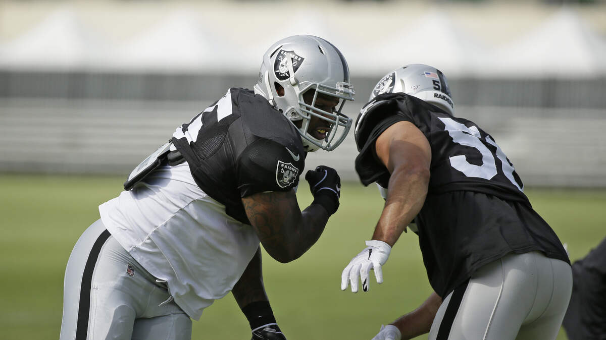 Oakland Raiders linebackers Vontaze Burfict, left, and Kyle Wilber take part in a drill Monday.