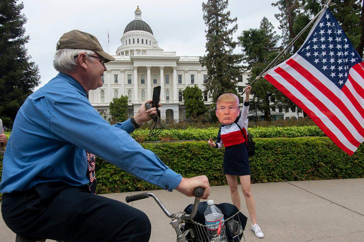 A woman identified as Miss America demonstrates at the Capitol in Sacramento on April 20, 2020, to protest the state’s stay-at-home orders to slow the spread of the coronavirus.