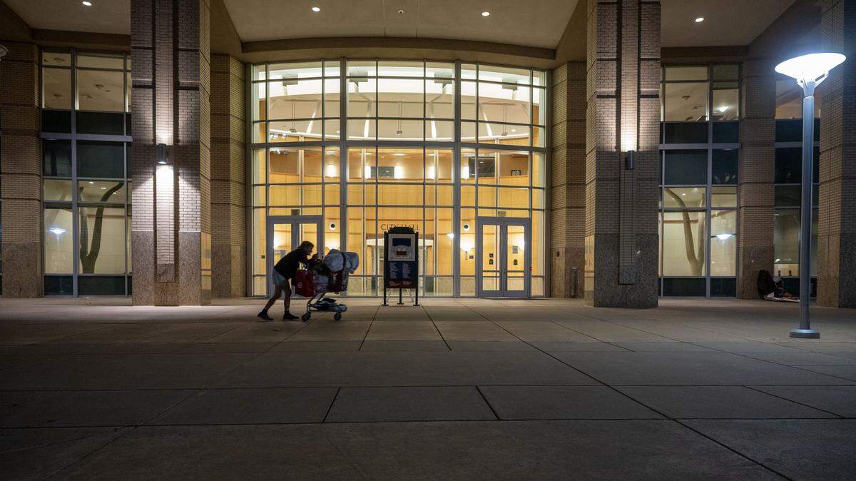 A homeless woman who declined to give her name walks past Sacramento City Hall on Wednesday, Aug. 27, the last night before an ordinance took effect prohibiting people from sleeping outside the building. The council voted 7-2 on Saturday night to prioritize pursuing a joint powers authority to manage affordable housing and homelessness services, 