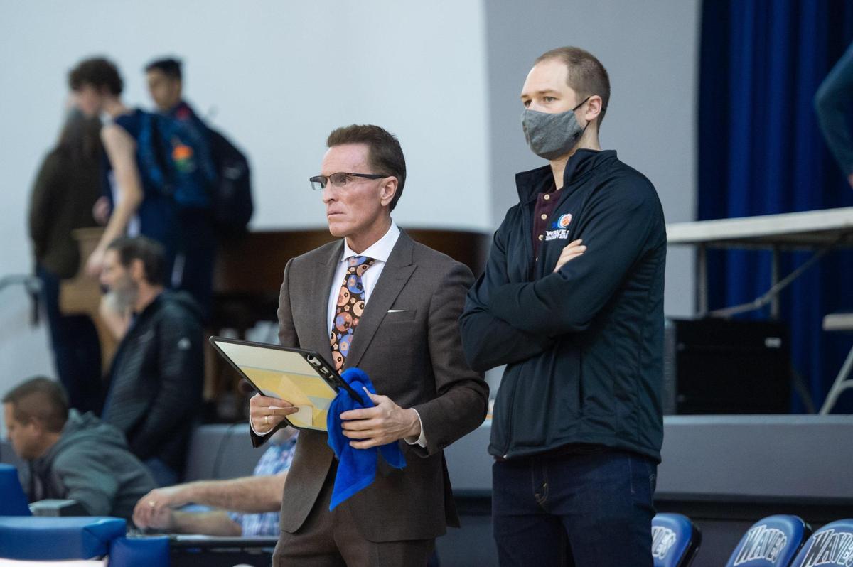 Waldorf Waves coach Dean Stark, left, and assistant coach Chris Schwartz-Edmisten watch John Adams Academy warm up before the game in December.
