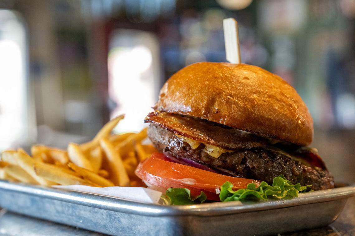 The Pangaea burger, a grilled chuck and brisket patty with cheddar cheese, applewood smoked bacon, lettuce, tomato, onion, house pickles and special sauce on a brioche bun, is served with fries at Pangaea Bier Cafe last month.