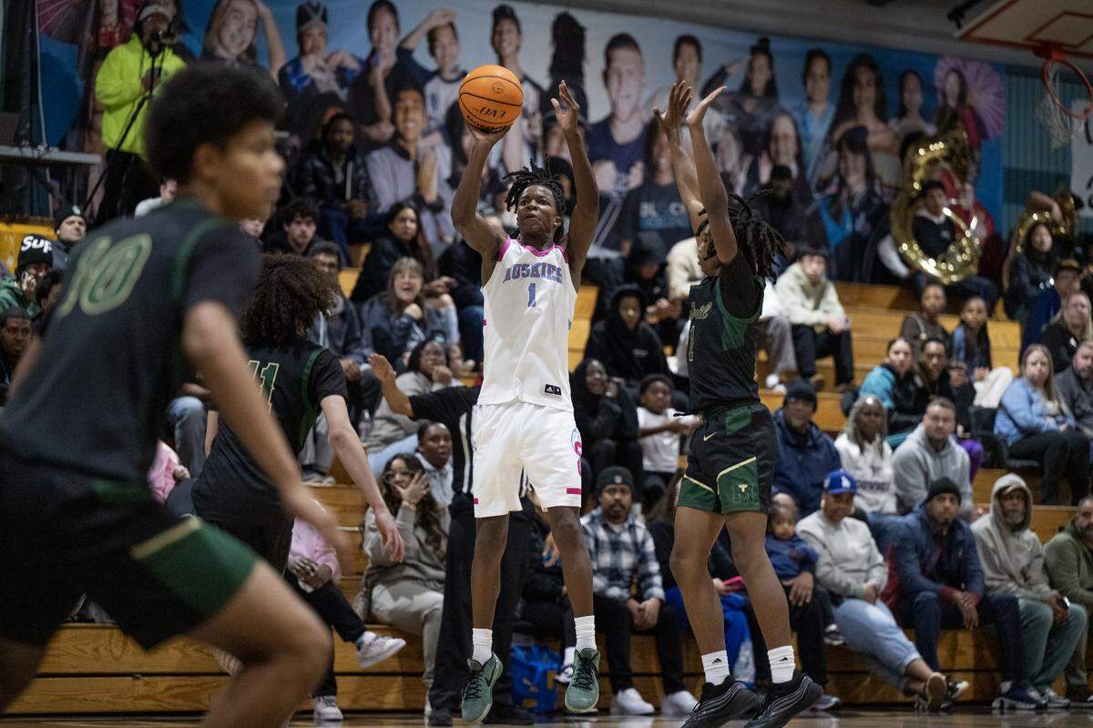 Sheldon Huskies' Baron Sabir (1) shoots past Monterey Trail Mustangs' Jaylen Williams (4) in the second half of a game on Wednesday.