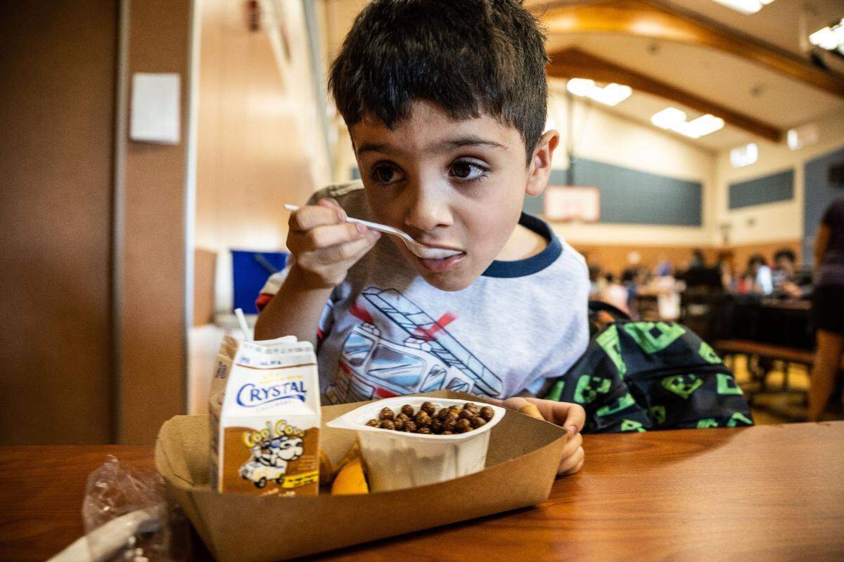 Amir, who said he’d like to be known as “SSSVVRRRR” and be a baker like his mother when he grows up, eats breakfast at Navigator Elementary School on Tuesday, Aug. 8, 2023, as students arrive on their first day back to school. Folsom Cordova Unified School District served more than three million free meals last year.