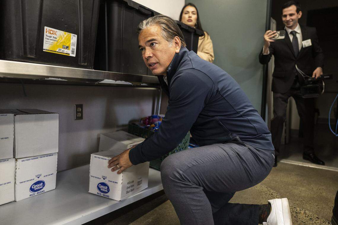 California Attorney General Rob Bonta helps organize a food pantry at Natomas High School with members of AmeriCorps and Improve Your Tomorrow on Tuesday.