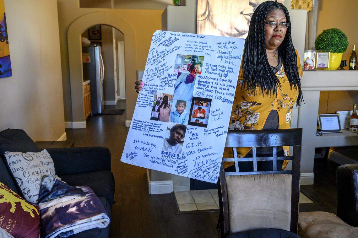 Chrisie Collins’ son Andre Erkins died in the Fresno County Jail in 2018. She holds a poster, made for her son Andre Erkins’ memorial service, at her home in Elk Grove in March.