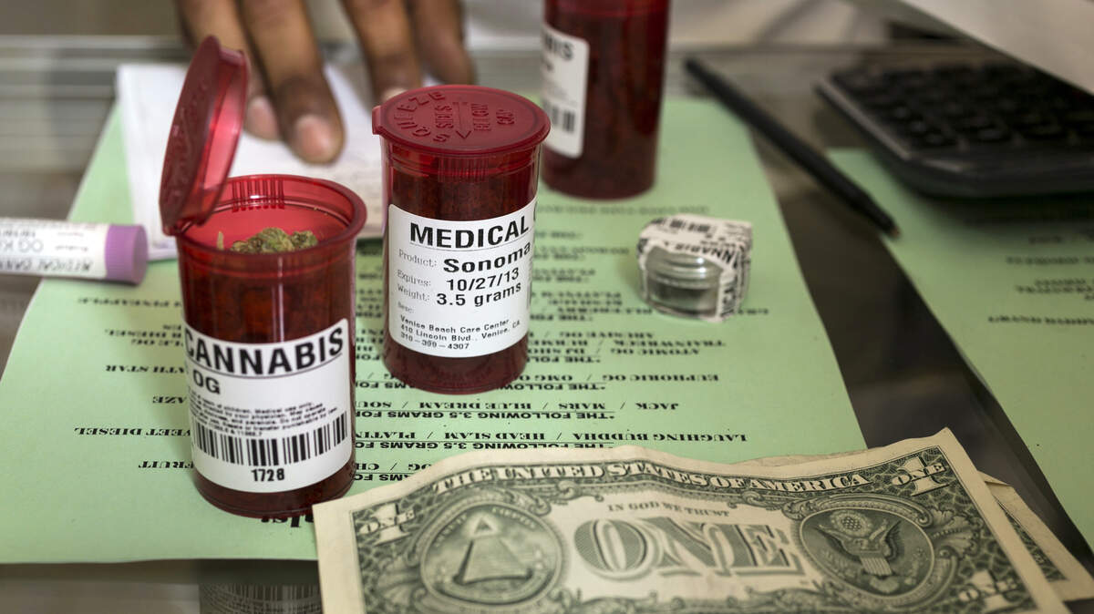 Medical marijuana prescription vials are filled at a dispensary in Los Angeles. A co-author of Proposition 64, which legalized recreational cannabis for adult use, is warning that proposed regulations will be unsafe for children.