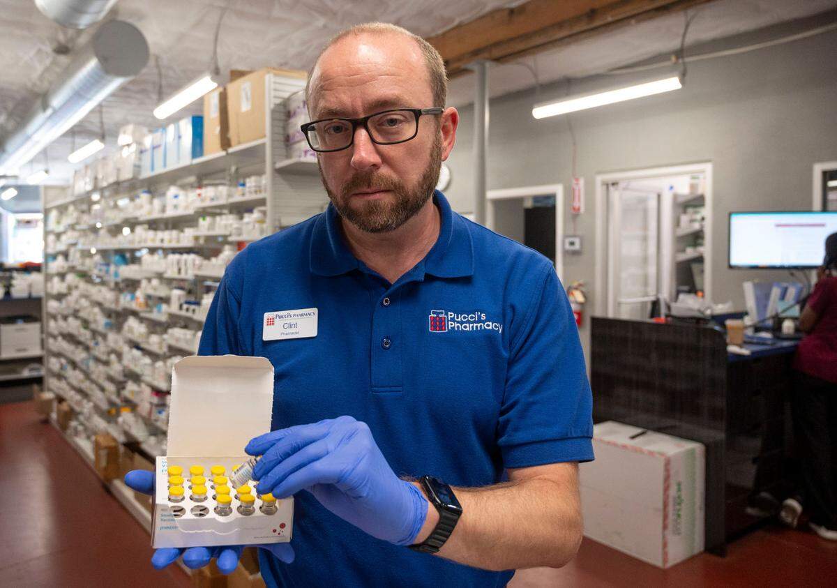 Clint Hopkins, co-owner and pharmacist of Pucci’s Pharmacy in East Sacramento, holds a box of monkeypox vaccines on Wednesday. The county provided Pucci’s with the vaccines at no charge, and his team started giving shots in July but have yet to be reimbursed. “We would have a major crisis on our hands,” said Hopkins, “if we hadn’t vaccinated at this rapid rate.”