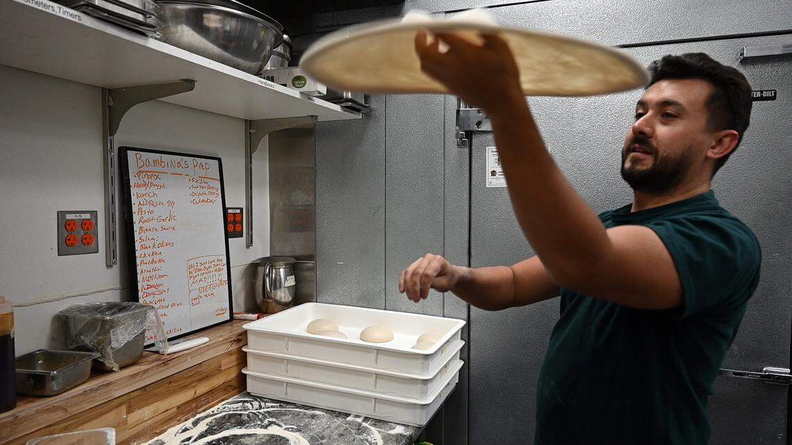 Owner Juanes Ramazzini spins pizza dough Thursday, Oct. 10, 2024, at Bambina’s Pizza and Pasta, which opened recently in midtown’s Ice Blocks development.