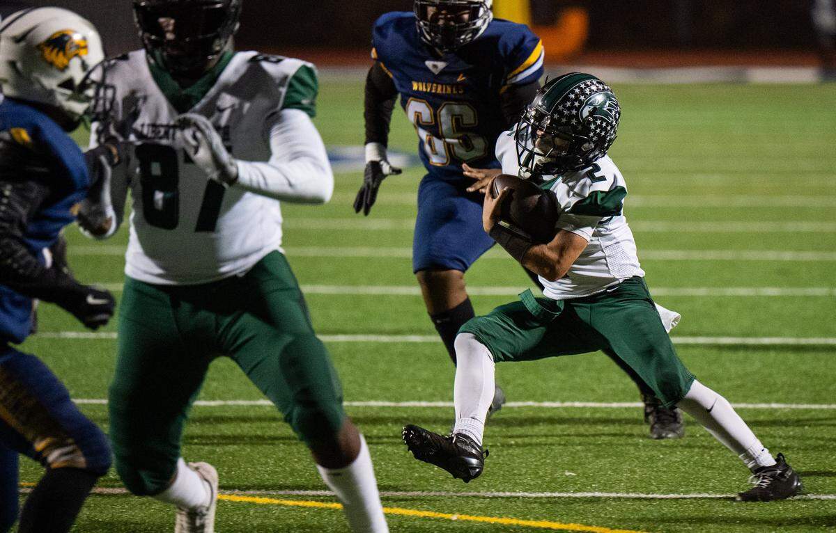 Liberty Ranch Hawks quarterback Ryan Ogas (2) makes a move on his way to a touchdown on a keeper against Rosemont on Friday in Rosemont. The undefeated Hawks conclude their regular season against crosstown foe Galt.  