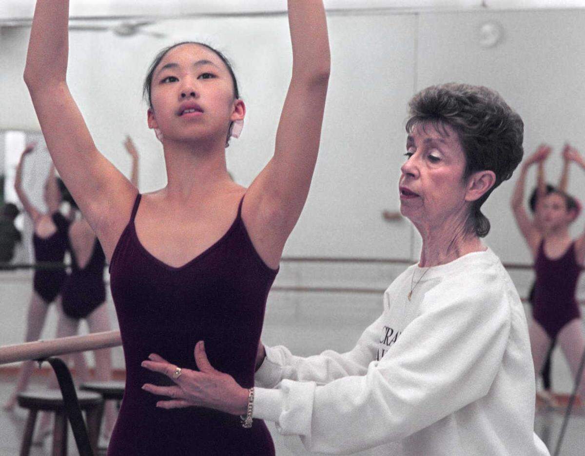 Barbara Crockett instructs Susan Fong, 12, during an apprentice company lesson at Deane Dance Center in 1995.