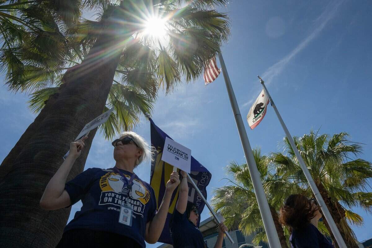 Members of SEIU Local 1000 protest outside the California Department of Public Health during a caravan demonstration against return-to-office requirements in Sacramento on Wednesday, June 10, 2026. SEIU Local 1000 members rallied to oppose state return-to-office policies affecting California government workers.