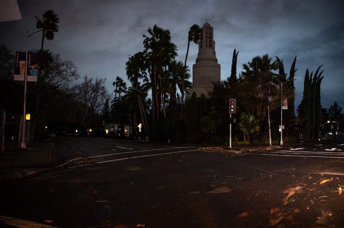 The Tower Theatre, alongside traffic lights and residences, loses power as high wind blows trees and debris throughout Sacramento and leads to major power outages across the region early Sunday, Jan. 8. 2023, as another major storm moves across Northern California.