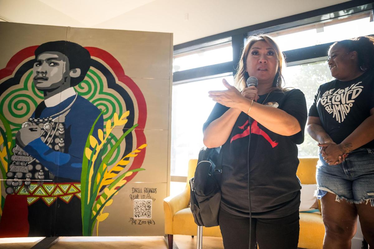Khoua “Christine” Vang, center, talks about the mural of her late son, Darrell Richards, alongside lead artist Shawntay Gorman before Sacramento’s first Blasian March on Saturday, Aug. 5, 2023, in Oak Park. Richards, a Black and Hmong man, was killed by Sacramento police in 2018.