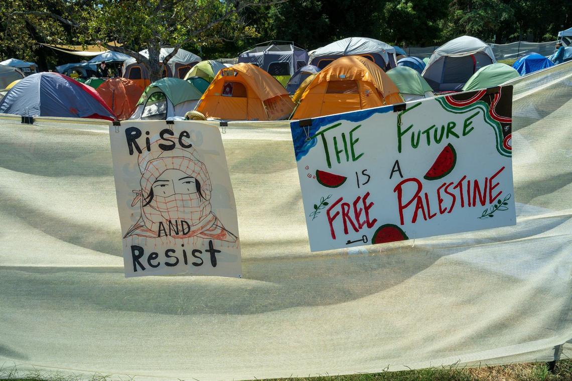 Signs mark the edge of the UC Davis encampment for the Davis Popular University for the Liberation of Palestine, which announced the end of their protest at a news conference on Wednesday, June 19, 2024.