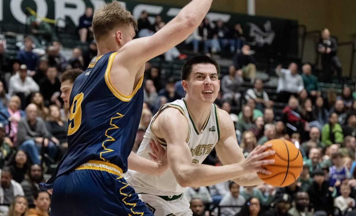 Sacramento State Hornets forward Mark Lavrenov (32) makes a move to the basket as Northern Arizona Lumberjacks forward Karl Poom (9) defends in the second half of a game on Jan. 15 in Sacramento.
