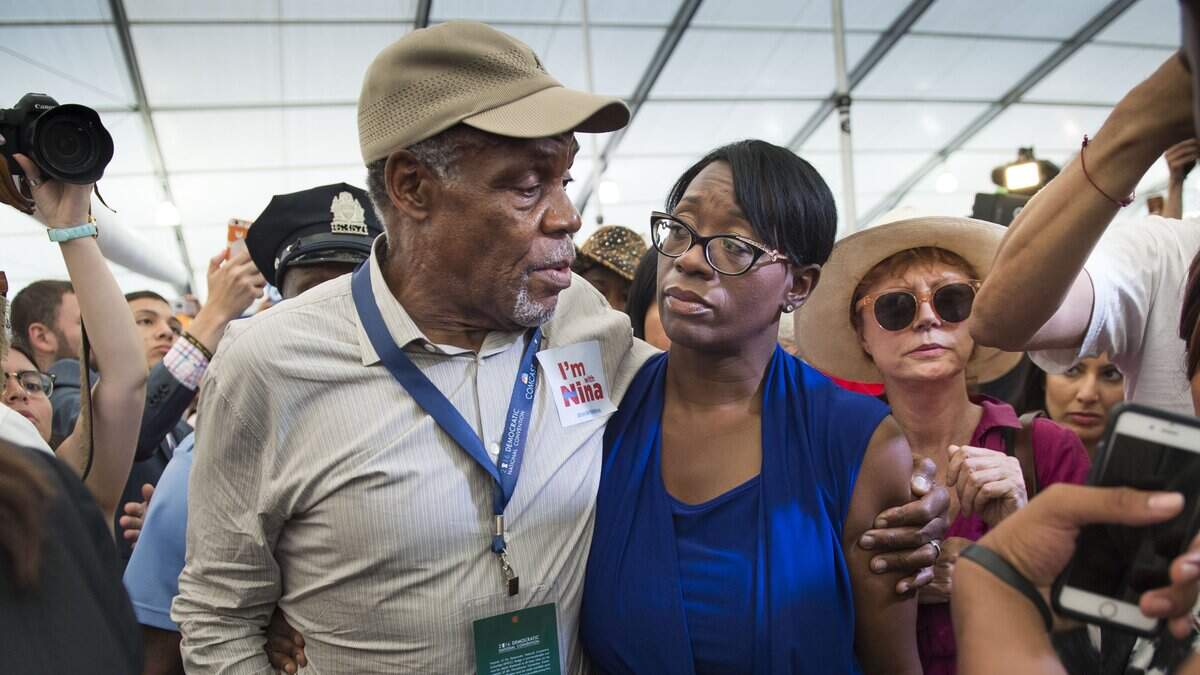 FILE -- Danny Glover walks with Nina Turner at the Democratic National Convention at the Wells Fargo Center on Wednesday, July 27, 2016.