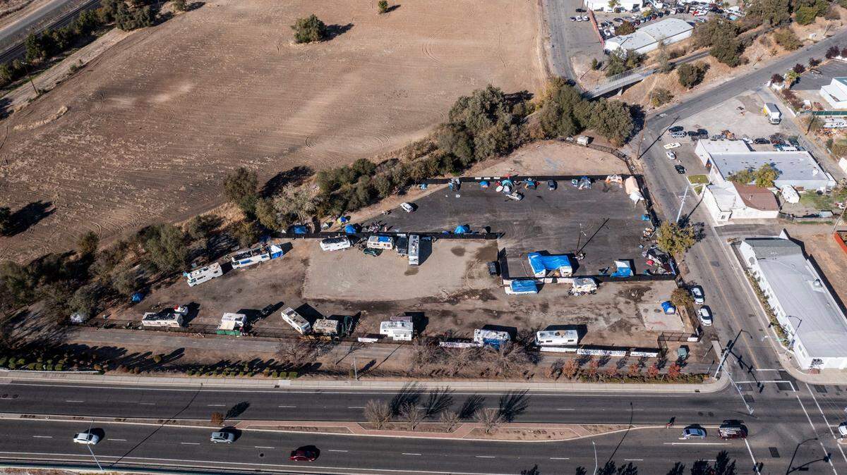 A homeless encampment on Colfax Street in North Sacramento is on city-owned property that state officials have deemed too toxic for people to inhabit. By Friday, Sacramento police had tagged every tent and RV on the lot, posting signs that said everyone had to leave.