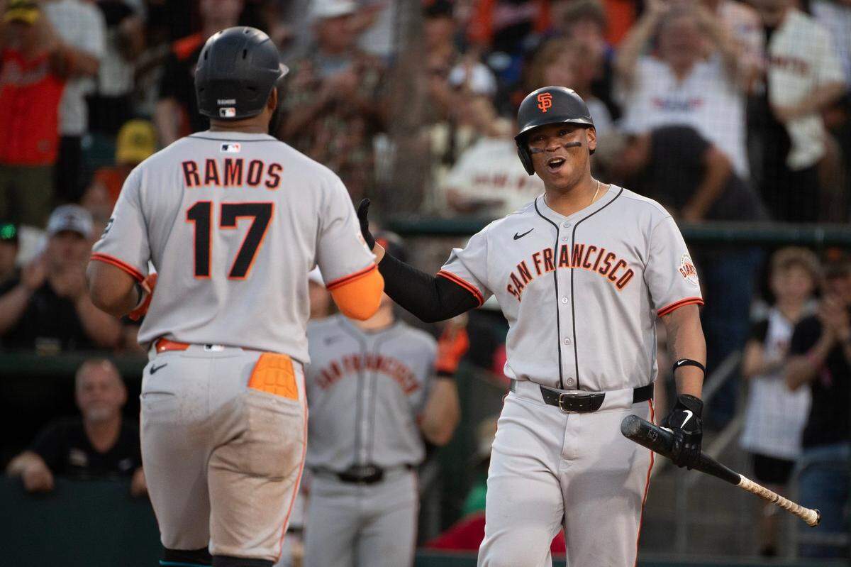 The San Francisco Giants’ Helios Ramos (17) is greeted by teammate Rafael Devers (16) after hitting a solo home run in the top of the fifth inning off Athletics pitcher Luis Severino on Saturday at Sutter Health Park in West Sacramento.