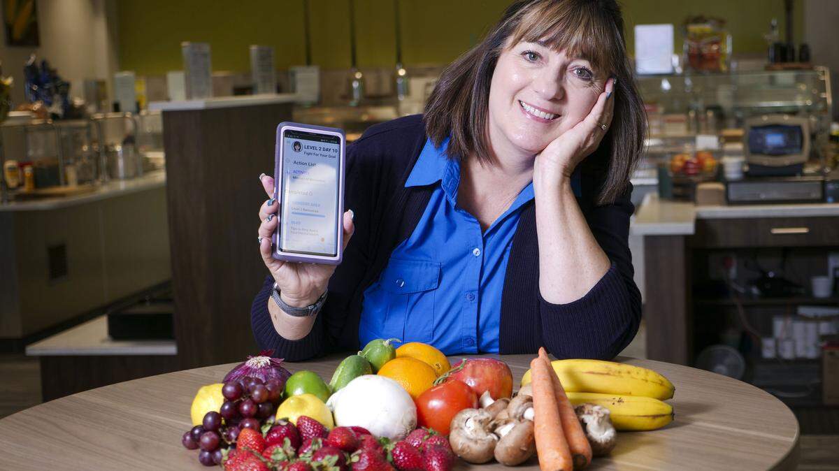 Blue Shield of CaliforniaÕs program coordinator Kim Stotler poses for a portrait with the new Wellvolution platform from Blue Shield, Wednesday June 18, 2019, at the office in Rancho Cordova, Calif. SheÕs been using the Betr Health app to guide her eating habits and health routines.