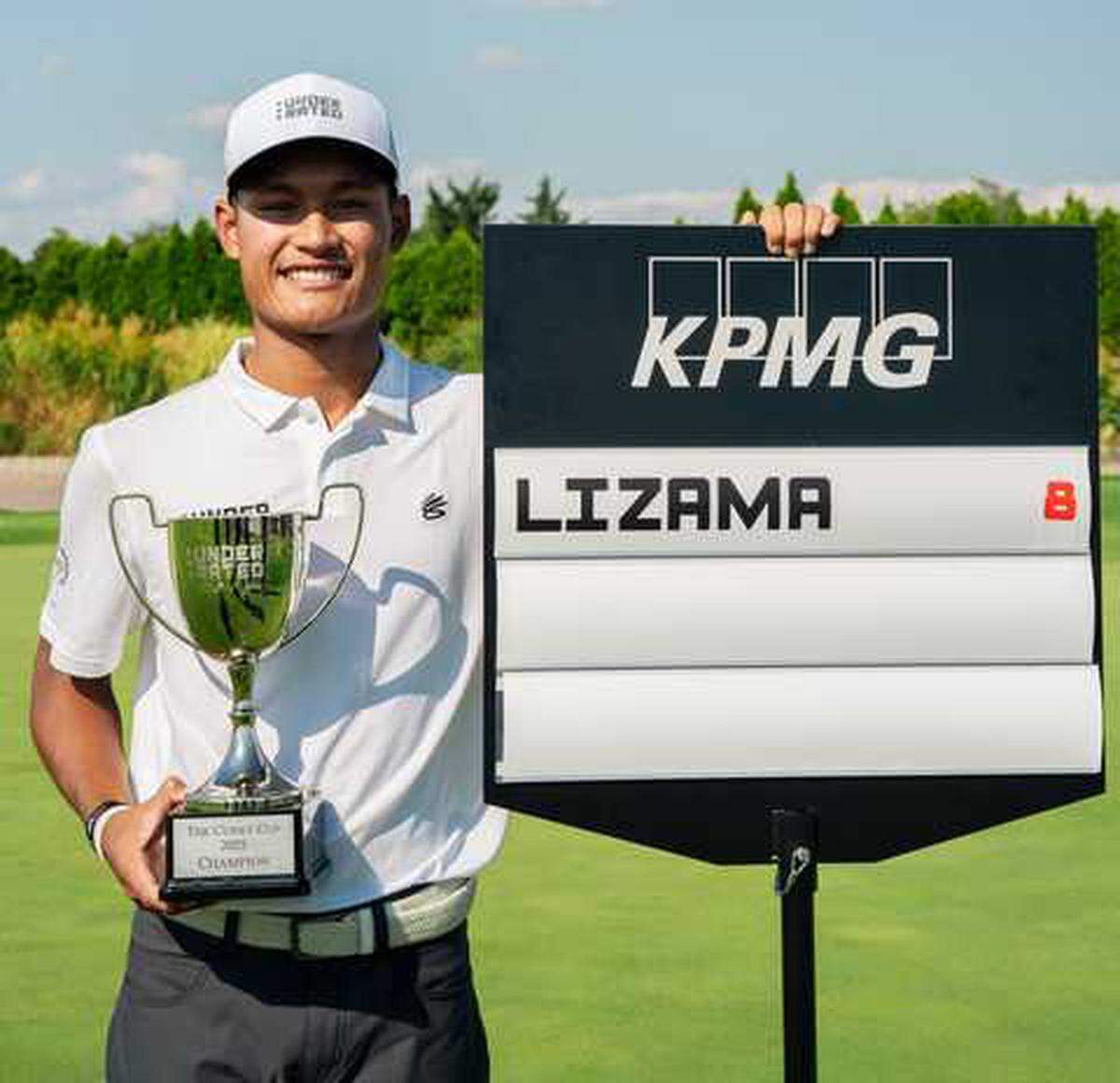 Jayden Lizama stands with his trophy and a tournament standard after winning the Curry Cup on Saturday, Sept. 13, 2025, at Liberty National Golf Club in Jersey City, N.J. Lizama, 17, won the season-ending championship of the Underrated Golf Tour with a score of 8 under par in his final junior event before beginning his college golf career at Gonzaga University.