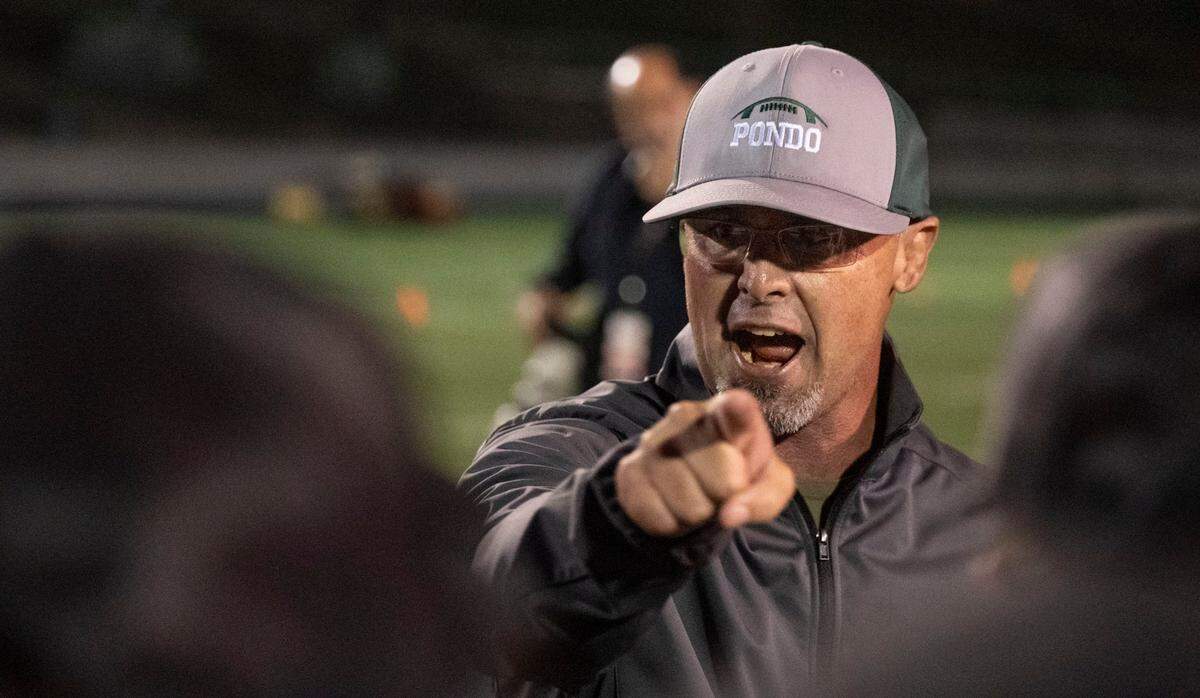 Ponderosa coach Tyson Escobar congratulates his team after they won the 2024 Sac-Joaquin Section Division II girls flag football championship game at Cosumnes River College. The Bruins were undefeated in their first season playing the sport.