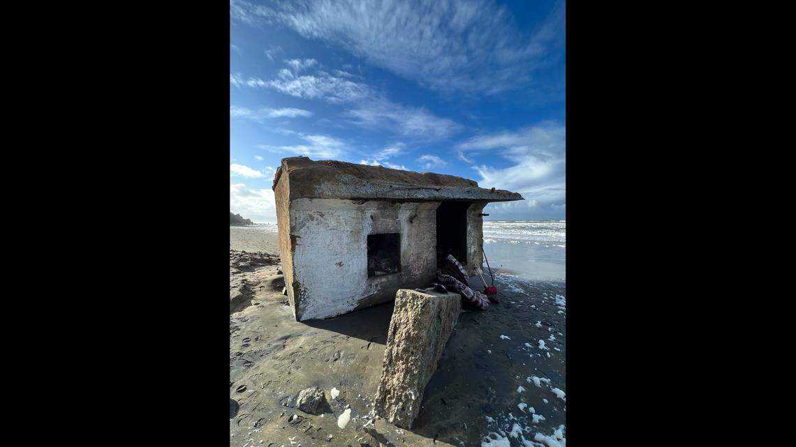 A massive World War II-era military structure tumbled 200 feet down from a sandy cliff onto a California beach, officials said.