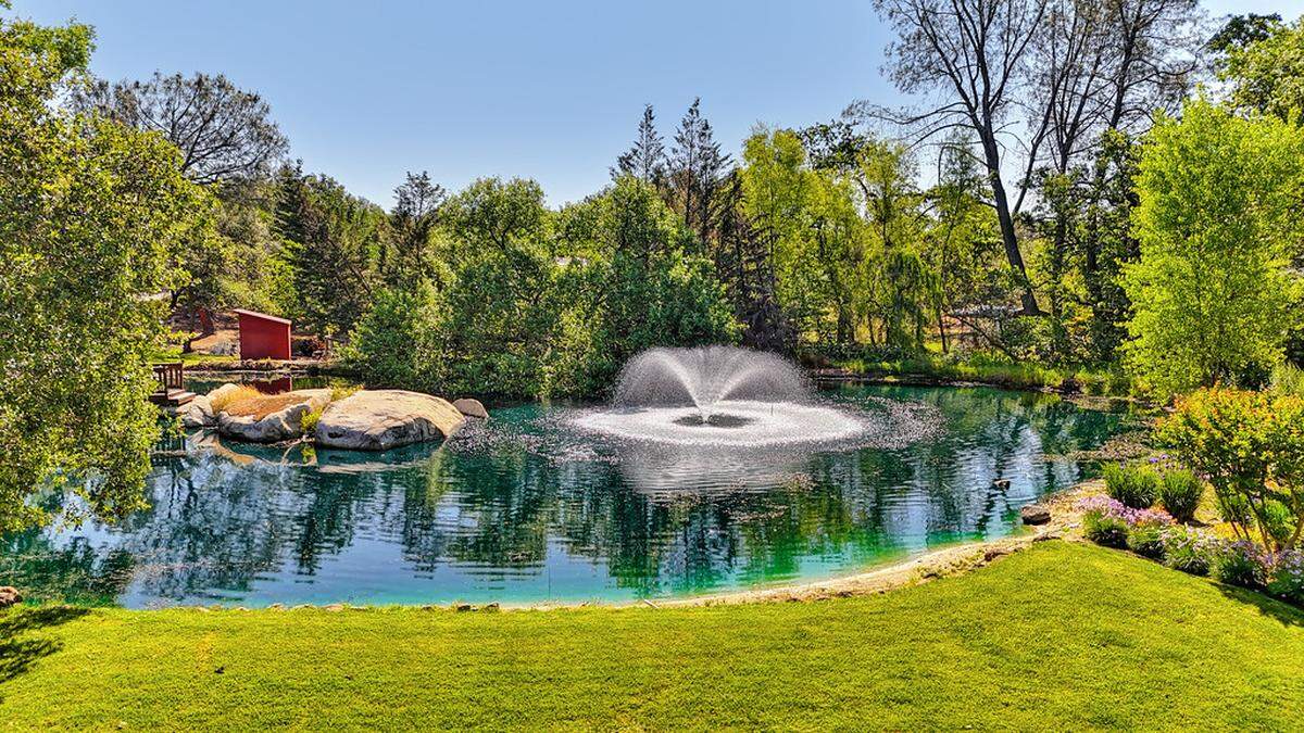 The pond is on prominent display in the front of the property and inspires home picnics.