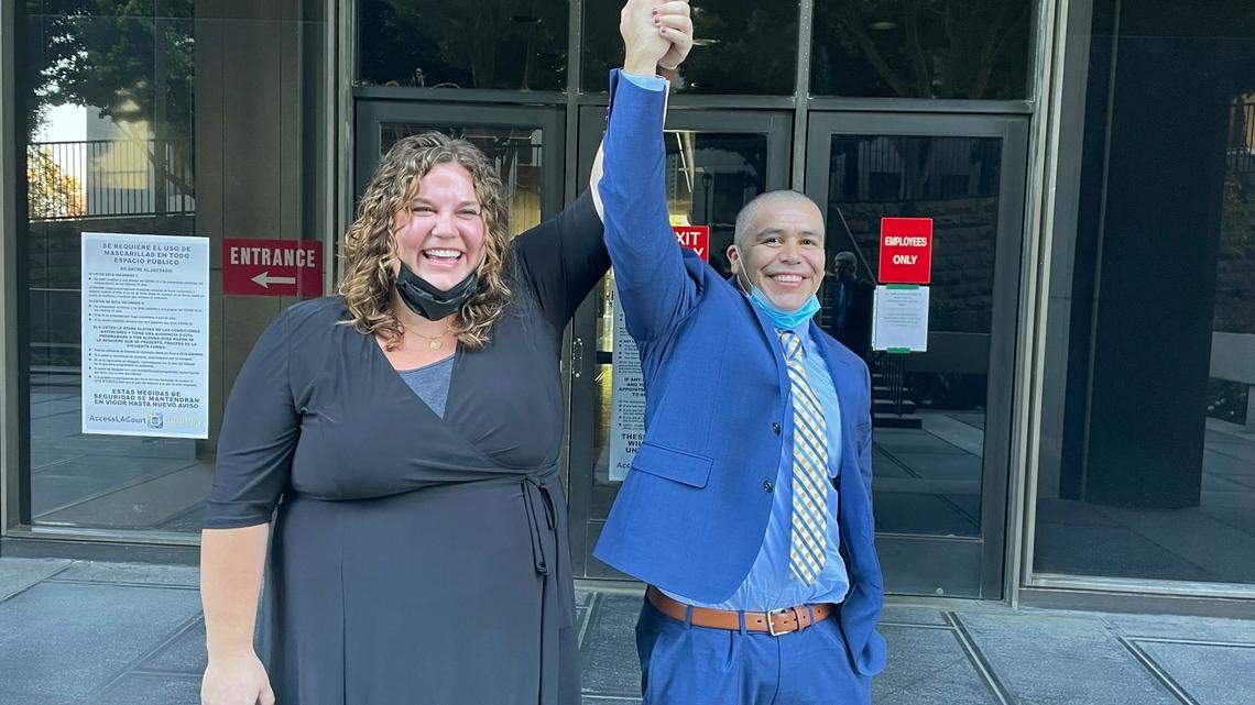 Attorney Audrey McGinn raises her hand with Alexander Torres after he was released from a Criminal Justice Center in Los Angeles on Oct. 19, 2021. (Jasmin Harris/California Innocence Project via AP)