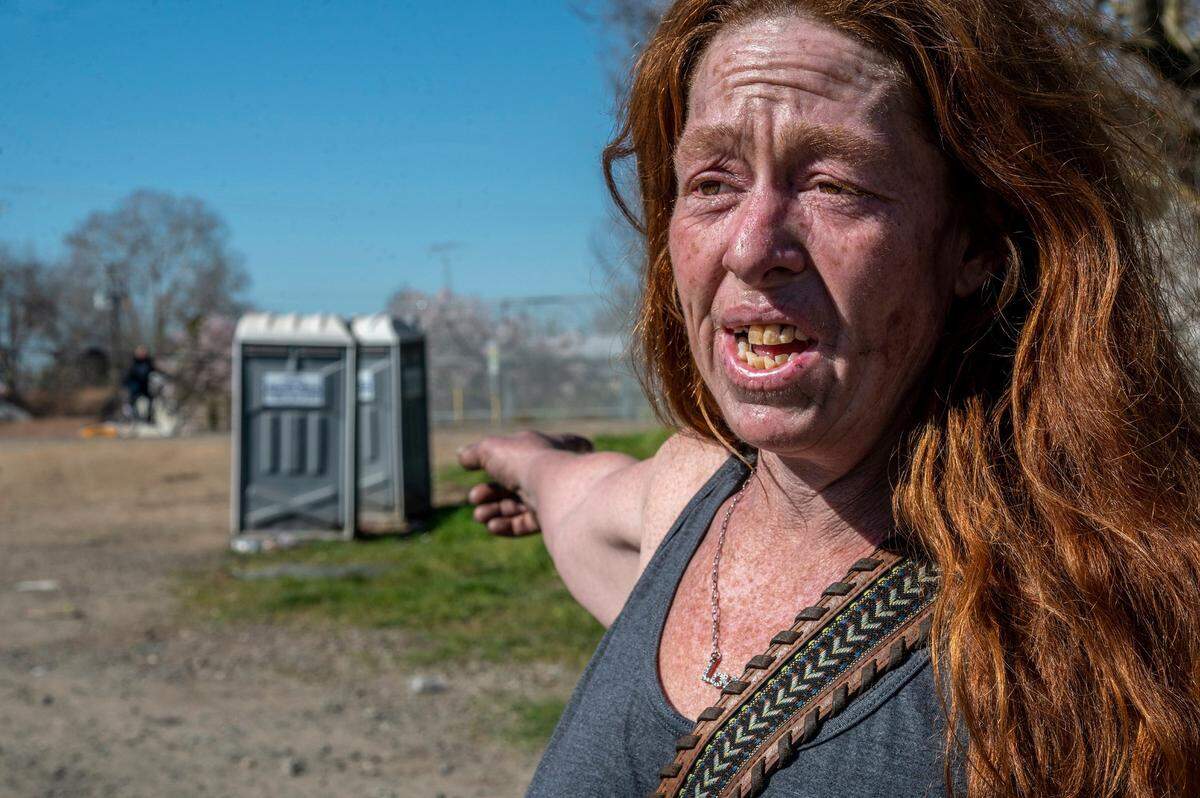 After using a port-a-potty along the American River at the large so-called “snake pit” homeless encampment, Ivone Carter, 40, voiced concern about their removal and the removal of the water stations. “Without a port-a-potties, we would have bags of feces laying around here everywhere and it gets nasty for us. Its a health risk,” Carter said.