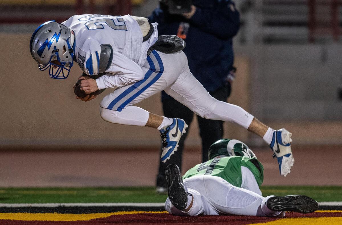 Rocklin Thunder defensive back Jack Merino (21) intercepts a pass in the end zone intended for St. Mary’s Rams wide receiver Ivan Huerta (4) in the second half of the CIF Sac-Joaquin Section Division II football championship game on Saturday at Hughes Stadium.