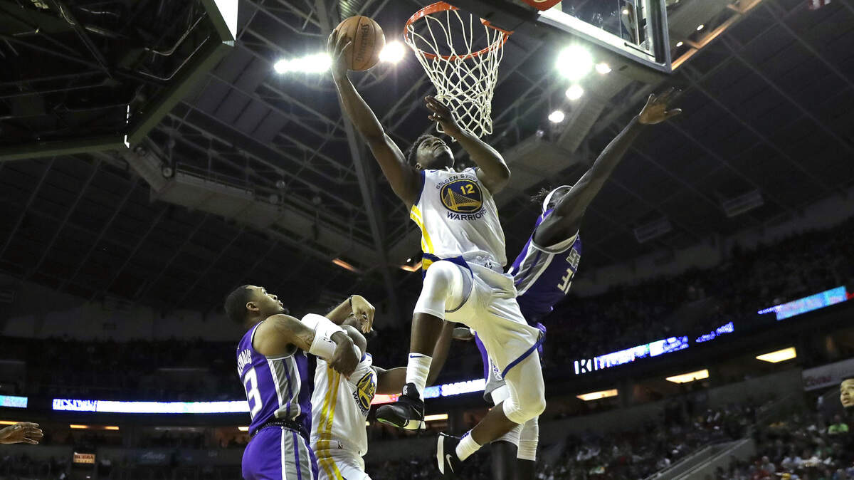 Golden State Warriors forward Danuel House Jr. (12) drives to the hoop past Sacramento Kings forward Wenyen Gabriel, right, during the second half of an NBA basketball preseason game, Friday, Oct. 5, 2018, in Seattle. The Warriors won 122-94. (AP Photo/Ted S. Warren)