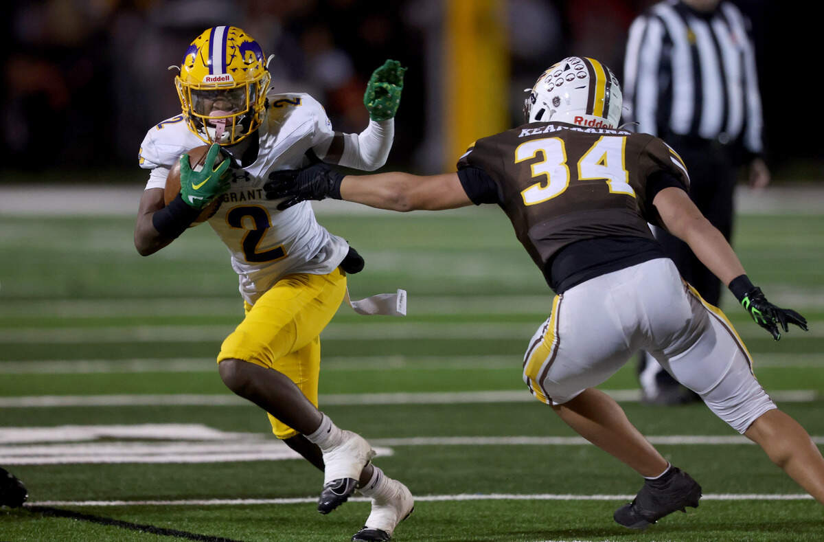 The Grant Pacers’ Koby Shabazz (2) tries to get around St. Francis’ Kevin Keanaaina (34) during the CIF Northern California Division 2-AA championship game on Friday, Dec. 6, 2024, in Mountain View.