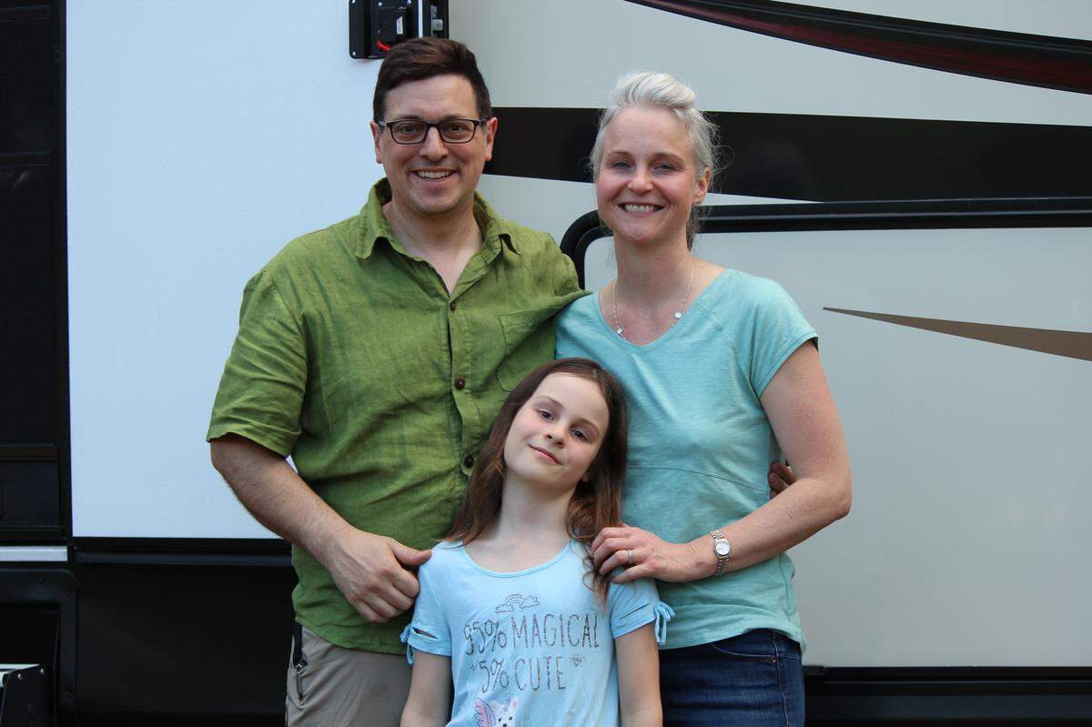 Before buying a new home in July, the Weddig family, Greg (from left), Eleanor and Nicole pose April 19 in front of their temporary residence, an RV in Chico, after the Camp Fire destroyed their home.