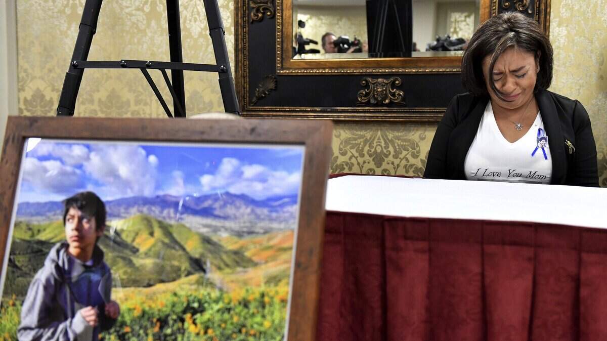 Juana Salcedo, aunt and guardian of 13-year-old Diego Stolz, cries during a news conference in Riverside on Oct. 29, 2019, announcing the family has started legal proceedings against the Moreno Valley Unified School District.
