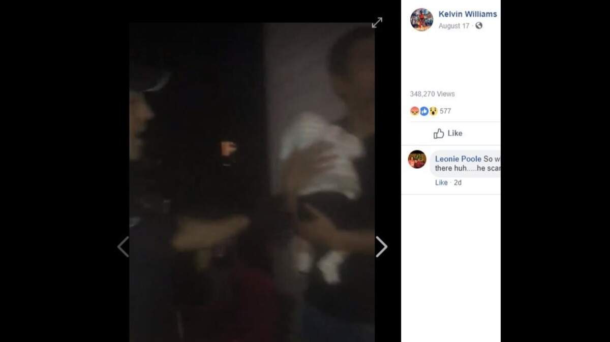 Ray Brown, 33, holds his 2-month-old son moments before police used a stun gun on him during a confrontation Friday night at a back yard barbecue in Michigan in a video shot by neighbor Kelvin Williams.