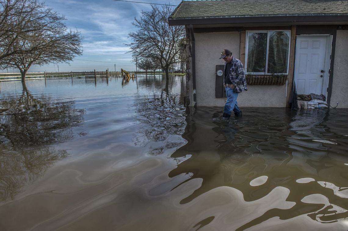 Jose Vargas departs his flooded house where he had to evacuate his family, seven horses, three dogs and a pet rabbit yesterday on Point Pleasant Road in 2017 in Elk Grove.