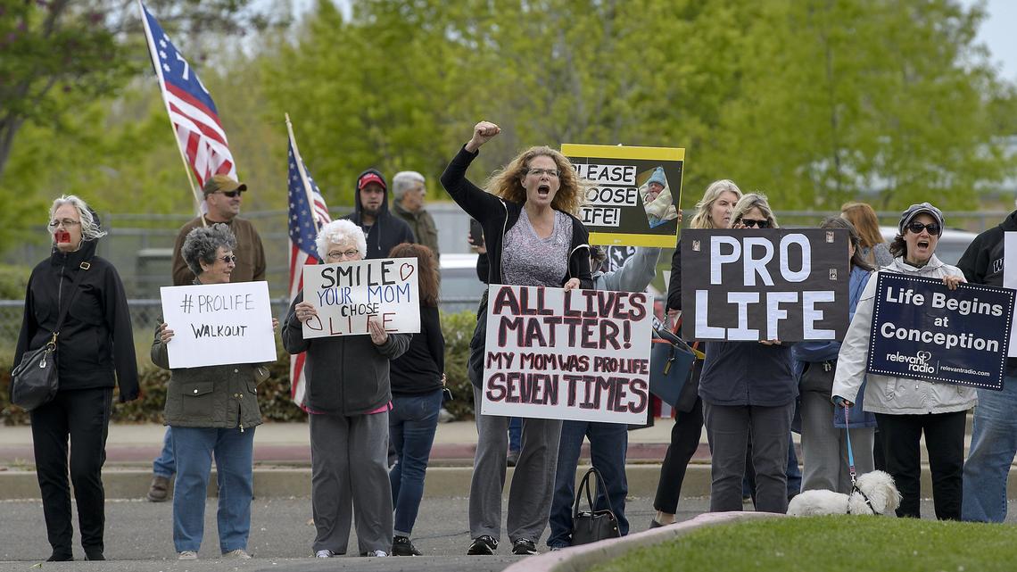 About two dozen adults demonstrate for a pro-life viewpoint on the sidewalk in front of Rocklin High School in Rocklin. Rocklin High was the epicenter of a national school pro-life walkout.