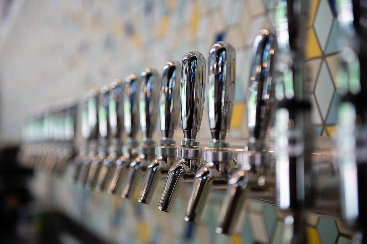 Beer taps line the wall at Urban Roots Brewing & Smokehouse in Sacramento.