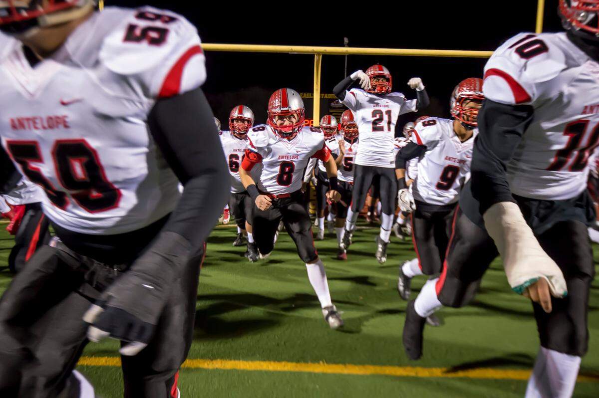 The Antelope High School Titans come on the to the field before playing Del Oro Golden Eagles in a Sac-Joaquin Section Division II playoff game Nov. 25, 2016.